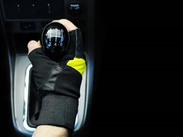 Gear lever. Manual Transmission. Hand on the gear shift in a car