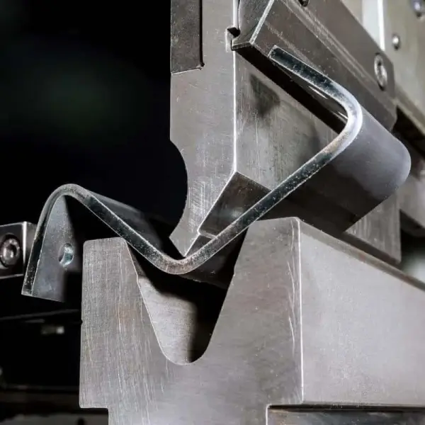 Metal forming machine in operation, bending steel.