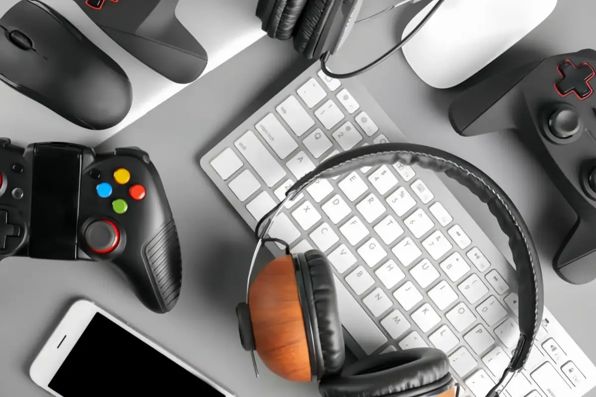 Gaming setup with controllers, keyboard, and headset.
