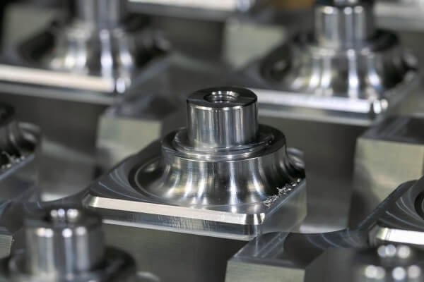 Batch of precision CNC-machined aluminum parts arranged for inspection